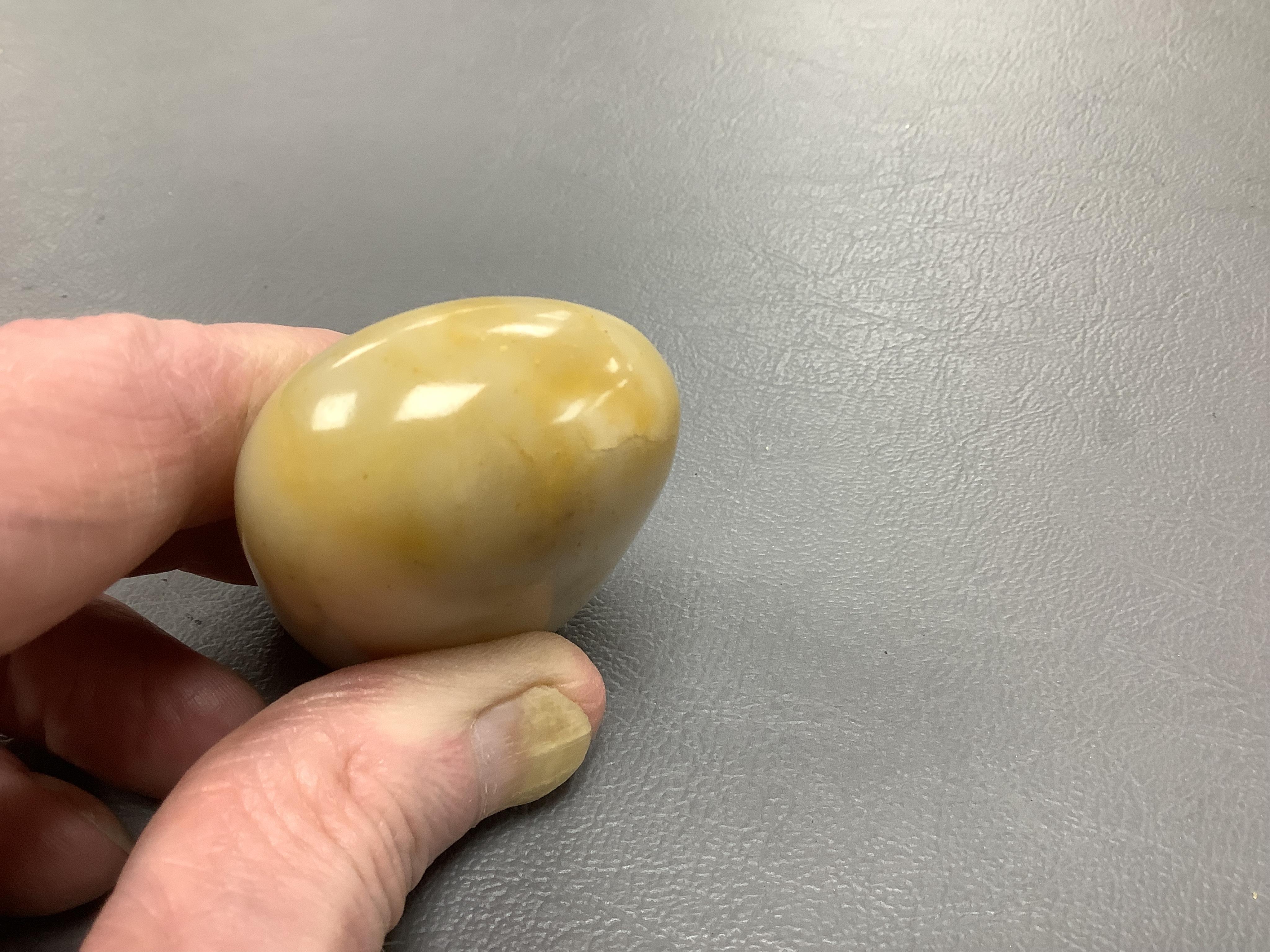 A 19th century Chinese white and russet jade pebble snuff bottle, 5.5cm in length
